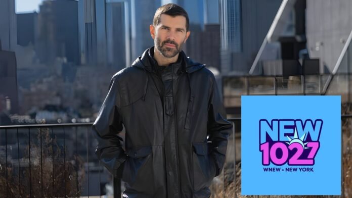 A photo of Mike Adam with the New 102.7 logo